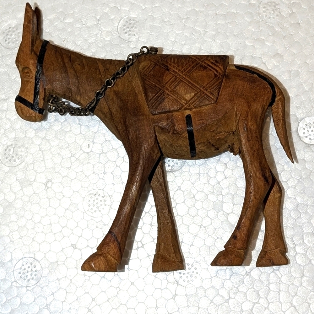 THREE exquisite hand carved wood animals. Two camels and a donkey.